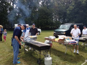PGK MIke Leyden cooking hamburgers, while Brother Bobby Zampese, Bobby Scanga and Franco Vitali look on. Brother Alan McGrath gets the cheese ready for the cheeseburgers.