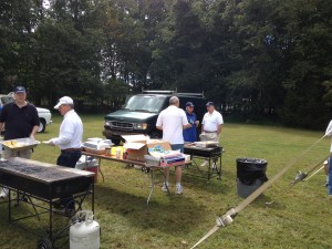 Brothers Pete Halko and Franco Vitali ready the hamburger rolls. While Alan McGrath, Tom Sanders and John Creamer watch after the grilling of the hot dogs.