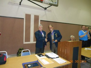 Lou Monteforte passing the gavel over to John Clary